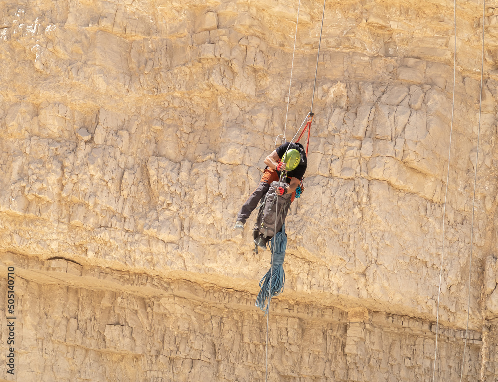 An experienced athlete athlete descends with the equipment for snapping in the mountains of the Judean Desert near the Tamarim stream near Jerusalem in Israel