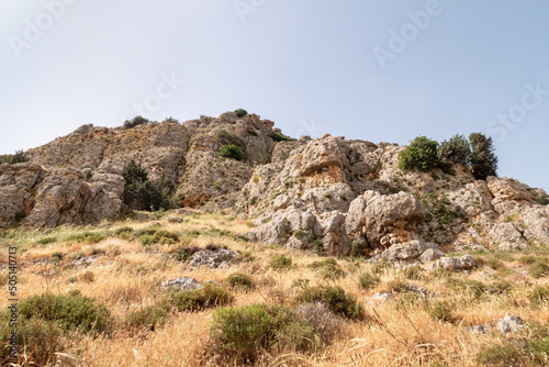 Overgrown with small crooked trees, grass and bushes, the slope of Mount Arbel, located on the shores of Lake Kinneret - the Sea of Galilee, near the city of Tiberias, in northern Israel.