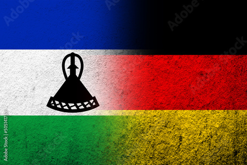 The national flag of Germany with The Kingdom of Lesotho National flag. Grunge background