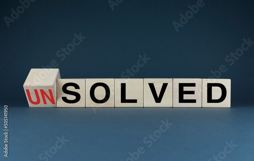 Unsolved or solved. Cubes form the choice words Unsolved or solved. photo