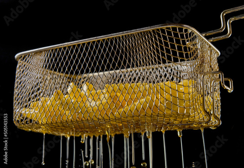 Fototapeta Naklejka Na Ścianę i Meble -  Fryer strainer on black background