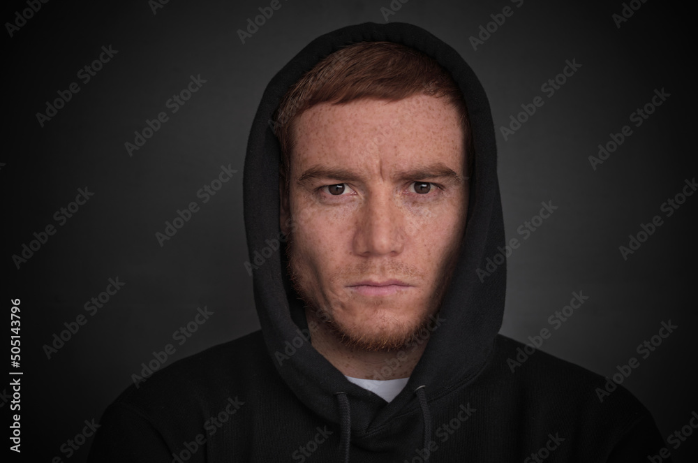 portrait of attractive middle aged red hair man in a black hoodie. strong man portrait. freckles face, melasma skin portrait of attractive middle aged red hair man in a black hoodie. strong man portrait. freckles face, melasma skin