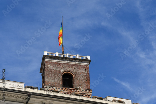 Top of the Torre Grimaldina, a medieval tower used for centuries as a prison, with a peace flag above the Palazzo Ducale in the centre of Genoa, Liguria, Italy photo