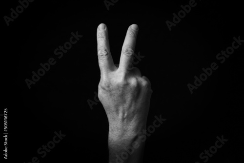 Reverse Victory Hand emoji isolated on black background photo