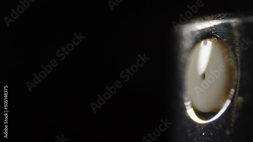 Macro shot of spray bottle in slow motion. Flow of water particles on a black background. Isolated