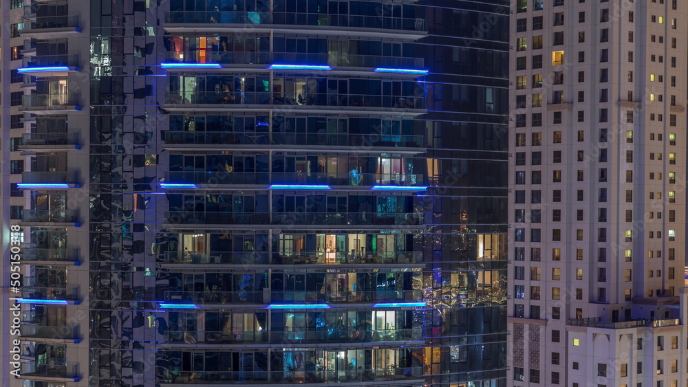 Obraz premium Windows of apartment buildings at night timelapse, the light from the windows of houses