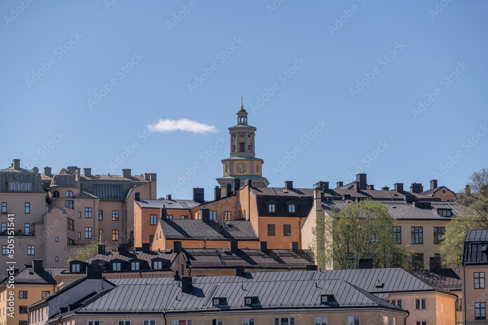 Φωτογραφία Old tin roofs and the spire of the church Maria kyrka in the district Södermalm