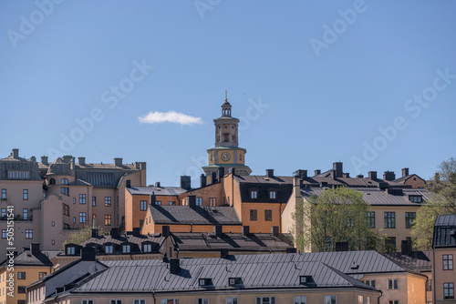 Old tin roofs and the spire of the church Maria kyrka in the district Södermalm a sunny day in Stockholm
