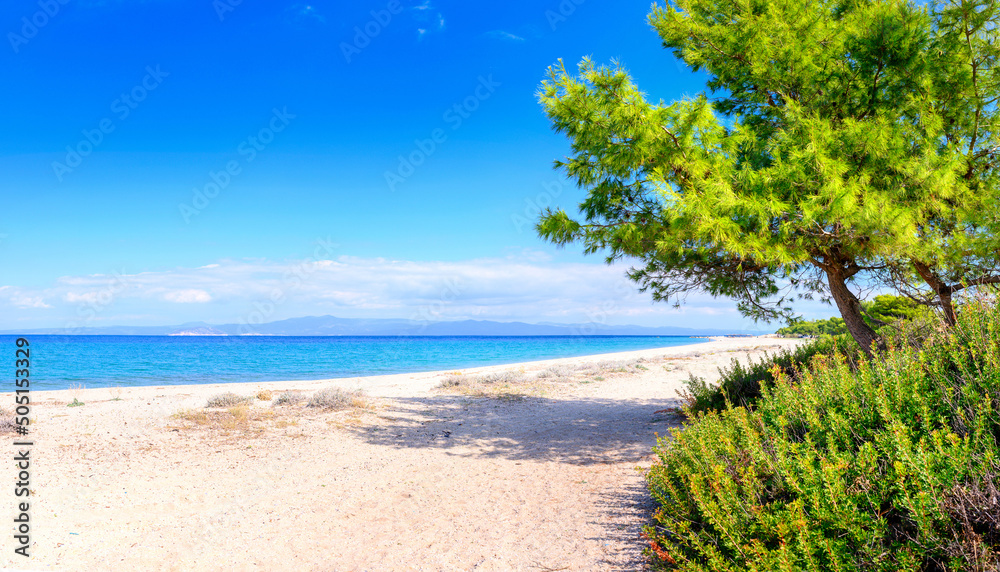 Landscapes view of beach sea sand and sky in summer day. Mediterranean Sea rolling in sunshine to the sandy beach.