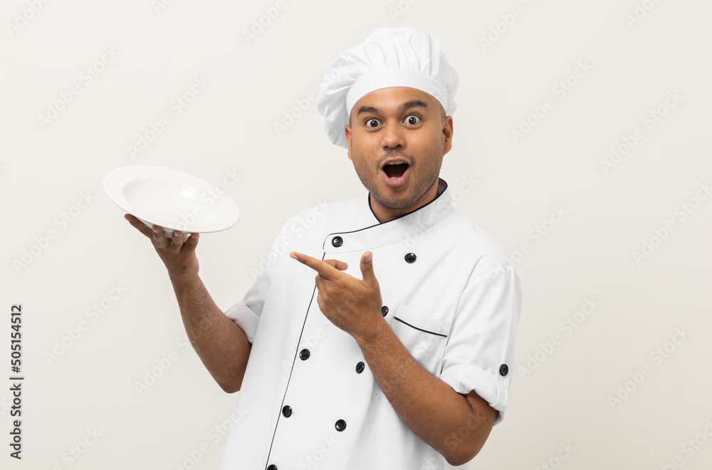 Attractive Young handsome asian man chef in uniform holding empty plate delicious dish menu good taste on isolated. Cooking indian man Occupation chef or baker People in kitchen restaurant and hotel. Attractive Young handsome asian man chef in uniform holding empty plate delicious dish menu good taste on isolated. Cooking indian man Occupation chef or baker People in kitchen restaurant and hotel.