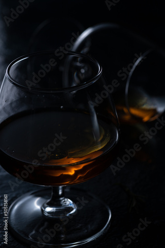 Two cognac glasses on a dark background