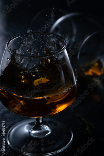Two cognac glasses on a dark background