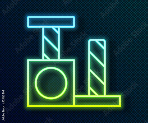 Glowing neon line Cat scratching post with toy icon isolated on black background. Vector