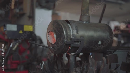 Blacksmith lights a fire in the forge. Damascus steel knife.Blacksmith lights a fire in the forge. Damascus steel knife.