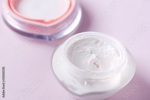 Close up of beauty cream in a pink container 
