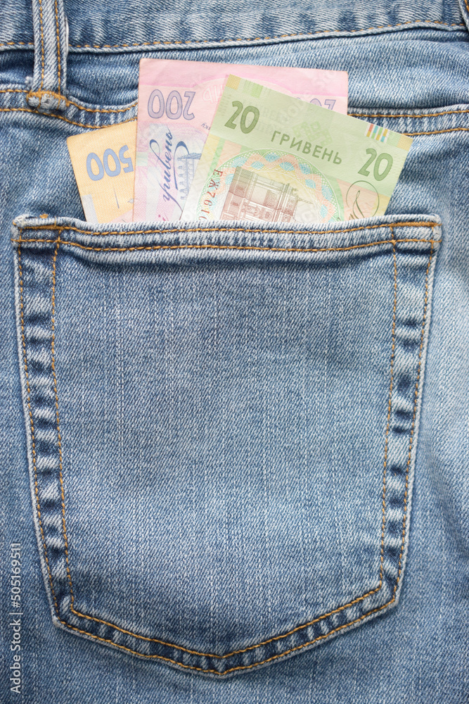 Ukrainian currency in hryvnias. Money, currency, Ukrainian banknotes of 500, 200 and 20 hryvnias. Ukrainian hryvnias banknotes in a jeans pocket, space for text, vertical photo. Ukrainian currency in hryvnias. Money, currency, Ukrainian banknotes of 500, 200 and 20 hryvnias. Ukrainian hryvnias banknotes in a jeans pocket, space for text, vertical photo.