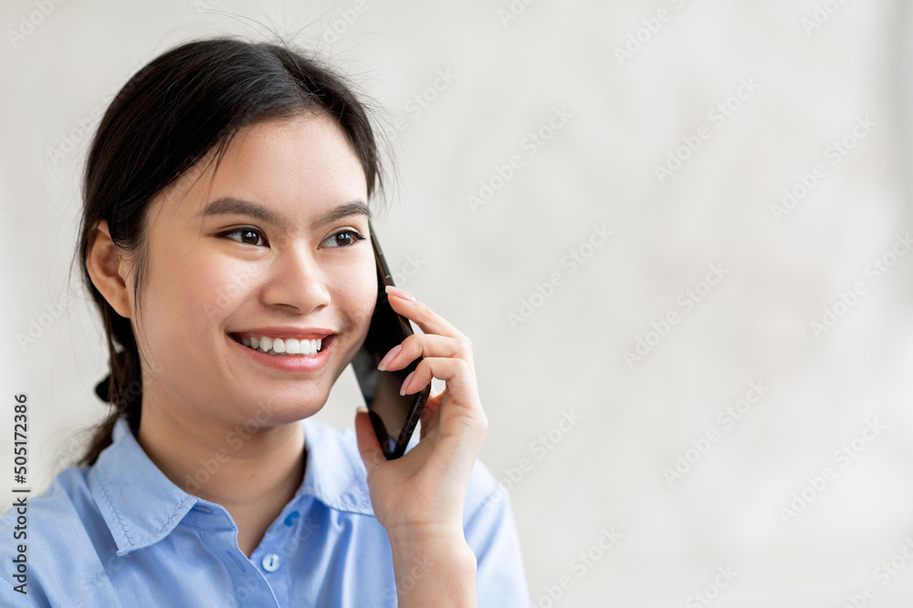 Closeup of cheerful chinese woman talking on cell phone Closeup of cheerful chinese woman talking on cell phone