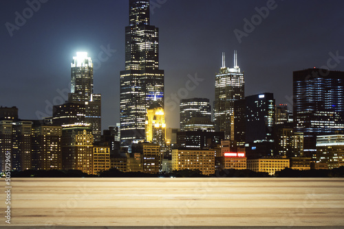 Empty tabletop made of wooden dies with Chicago city view at evening on background  template