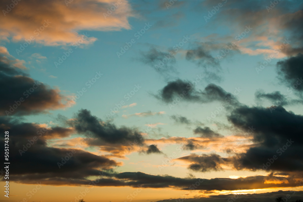 Sunset in springtime with golden light and stormy looking stratocumulus clouds. Kildare, Ireland