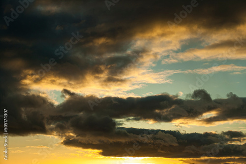 Sunset in springtime with golden light and stormy looking stratocumulus clouds. Kildare, Ireland photo