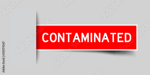 Inserted red color label sticker with word contaminated on gray background