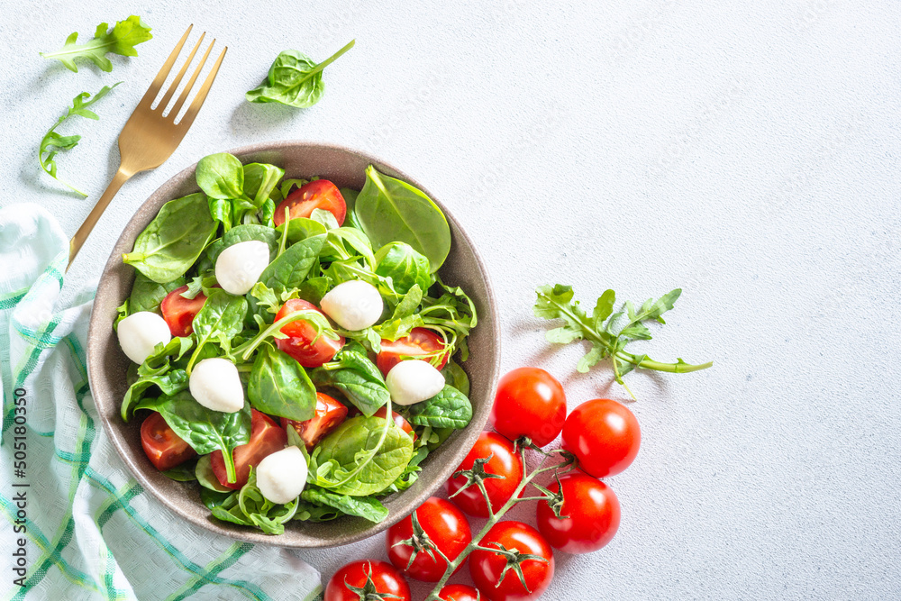 Green salad with fresh leaves, tomatoes and mozzarella. Green salad with fresh leaves, tomatoes and mozzarella.