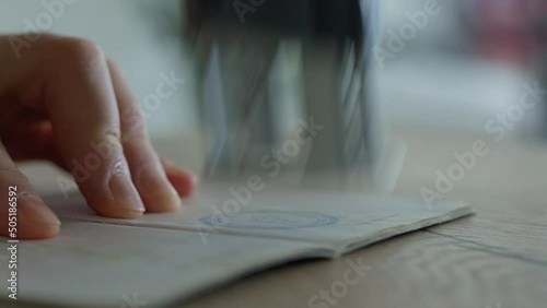 One employee takes a passport in hand and puts a entry stamp. To give the entry visa. Border control has allowed entry into the country