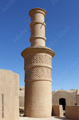 The minaret of deserted village of Kharanaq, Yazd District, Iran photo