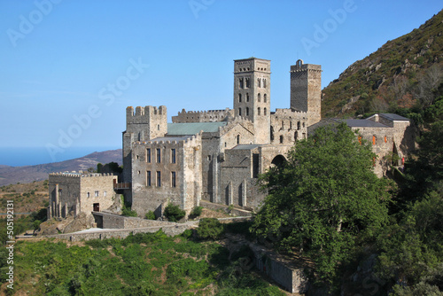 The romanesque monastery of Sant Pere de Rodes with its bell tower on a mountain slope in Catalonia, Spain