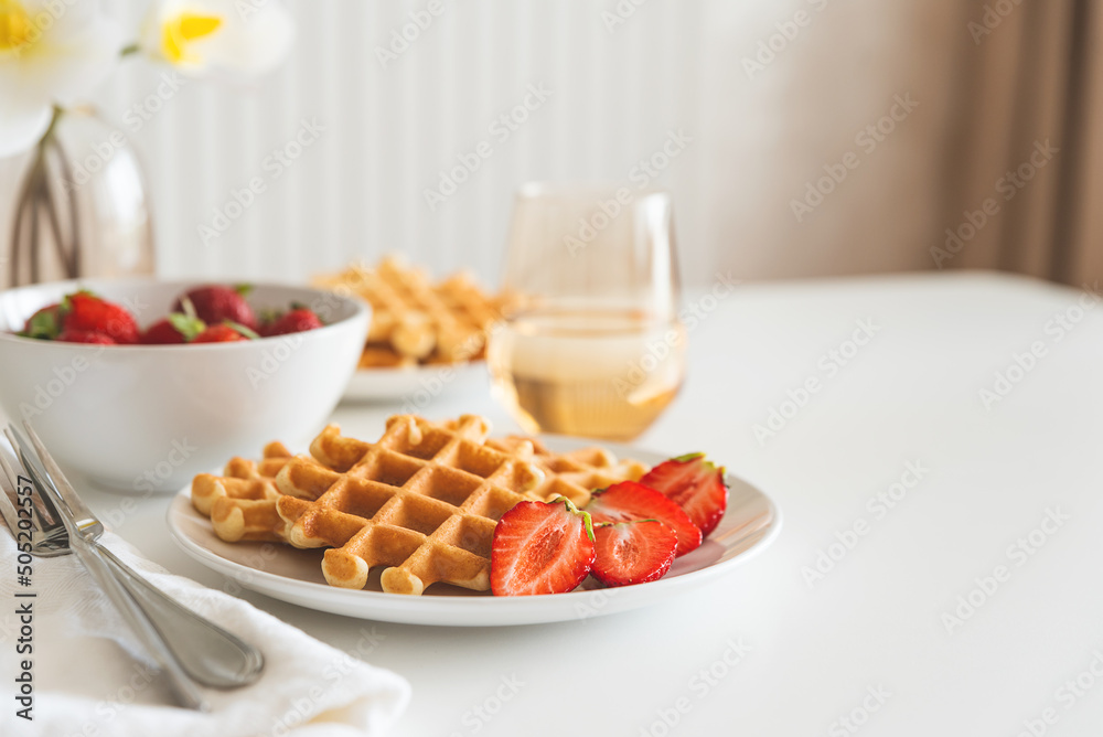 Belgian waffles with strawberry on white plate. Breakfast food concept. Copy space Belgian waffles with strawberry on white plate. Breakfast food concept. Copy space