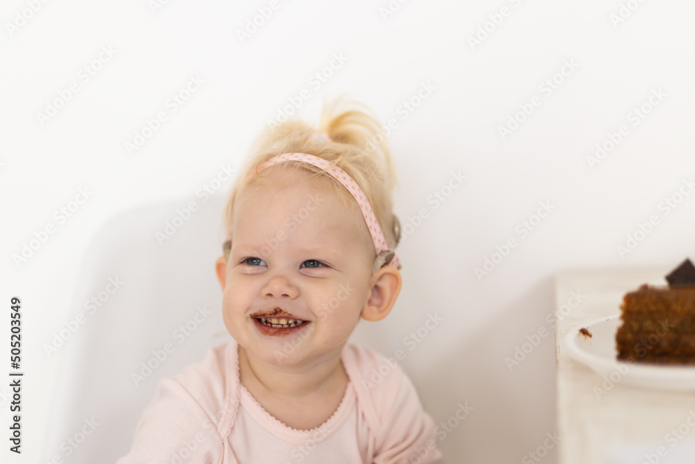 Baby with cochlear implants at home. Deafness and medical technology and diversity concept. Baby with cochlear implants at home. Deafness and medical technology and diversity concept.
