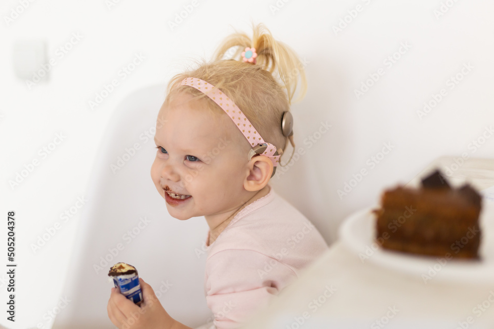Cochlear implant for baby. Deaf child with hearing aid. Health care and medicine technology and innovations and diversity Cochlear implant for baby. Deaf child with hearing aid. Health care and medicine technology and innovations and diversity