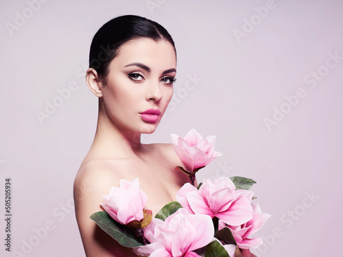  Fashion photo of a beautiful woman. Fashion model posing with flowers.  