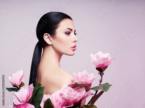 Fashion photo of a beautiful woman. Fashion model posing with flowers.   photo