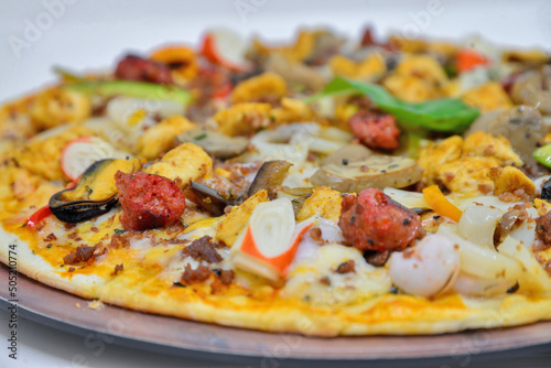 Chicken sausage and seafood pizza. isolated on a white background