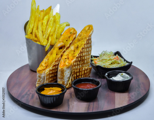 French tacos with french fries with ketchup and mayonnaise. isolated on a white background photo