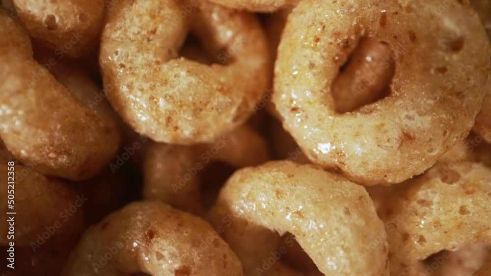 Macro view of cereal circles in bowl.
