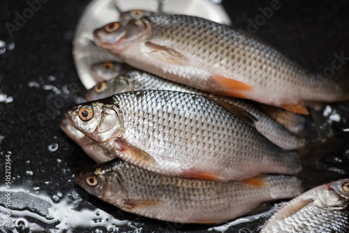 A bunch of fresh fish on the kitchen table with focus blur. The concept of cooking, marinating fish. Close-up