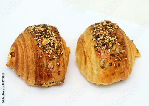 Fresh croissant on a white background, perfect for breakfast.