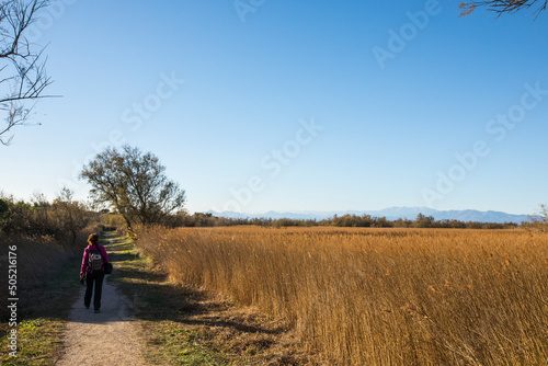 Young girl walking and photographing birds in AIguamolls De L Emporda Nature Park, Spain © Alberto Gonzalez 