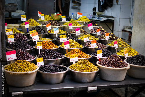 Variety of olives for sale on Suq (arabic price tags) photo