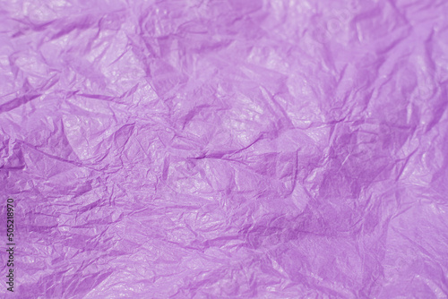 The texture of crumpled pink paper. Paper for wrapping gifts and flowers. Abstract background made of tishyu paper.