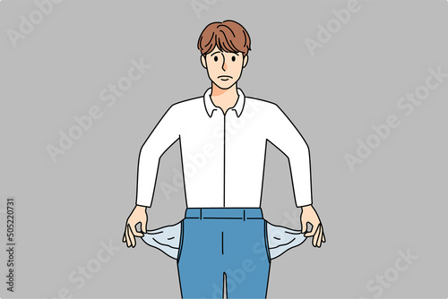 Stressed businessman show empty pockets 