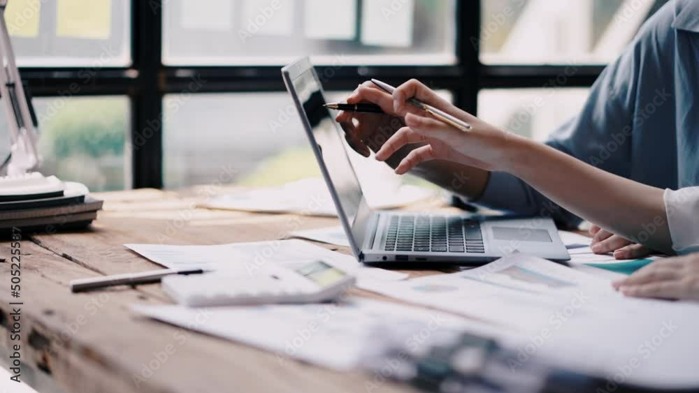 Business people discuss investment project working and planning strategy on laptop computer.