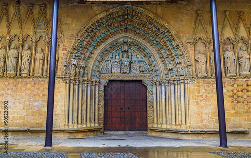 Romanesque portal of the Santa Maria la Real church decorated with carvings and statues of the saints on the archivolt and the facade in Olite, Spain photo