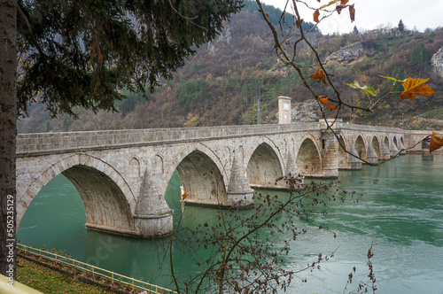 Historic Bridge over the Drina River, Ivo Andric, Famous Tourist Attraction. The Mehmed Pasa Sokolovic Bridge in Visegrad, Bosnia and Herzegovina. Balkans. photo