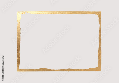 Gold (bronze) glitter empty frame on beige gray paper background. Abstract copy space texture. photo