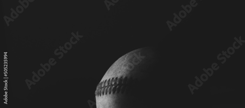 Photography Dramatic baseball image of old used sports ball in black and white closeup with selective focus on game ball, copy space on banner background