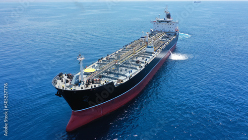Aerial drone photo of crude oil tanker carrier anchored in deep blue open ocean sea © aerial-drone