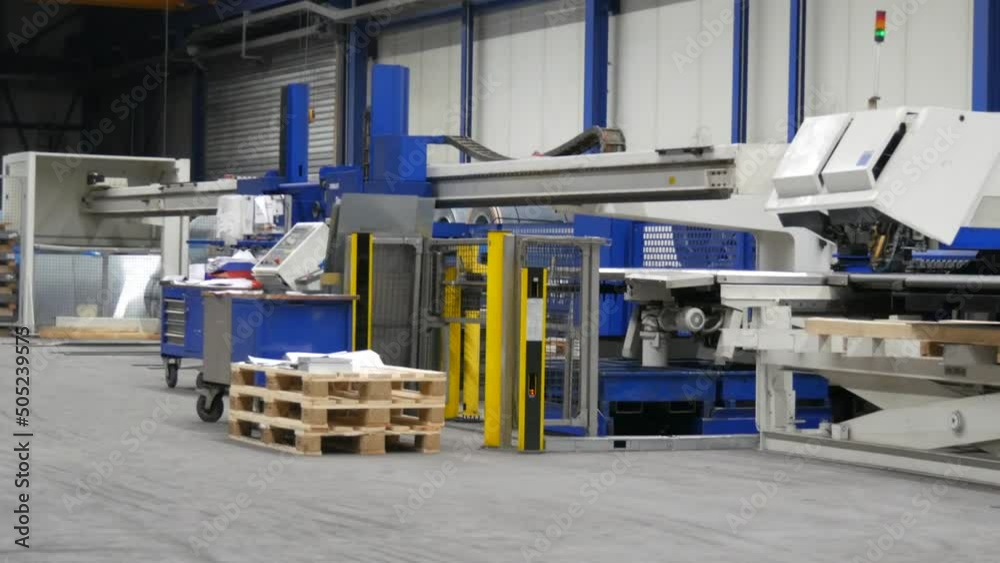 An empty deserted hall of an industrial hall for metal processing. Industrial manufacturing concept, around pallets with products, shelves and tools. Metalworking, industrial, equipment, technology An empty deserted hall of an industrial hall for metal processing. Industrial manufacturing concept, around pallets with products, shelves and tools. Metalworking, industrial, equipment, technology
